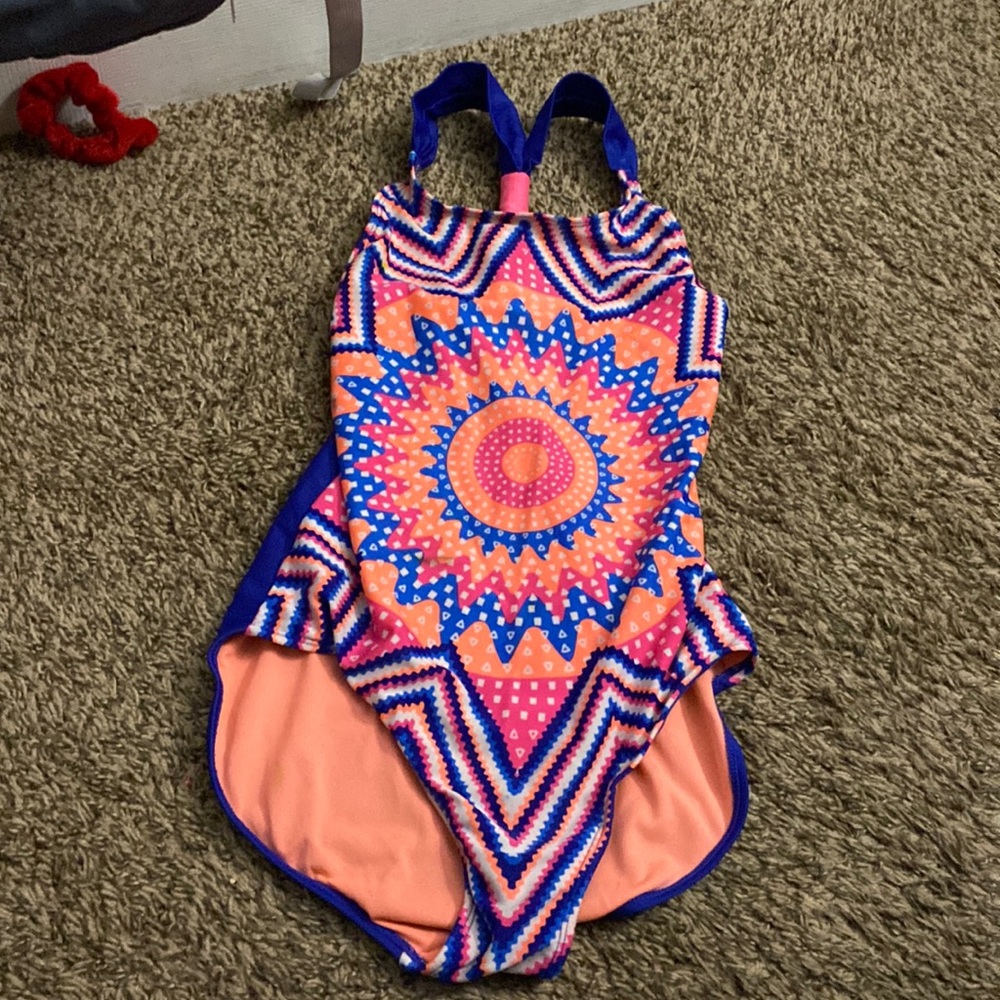 A fun colored 1 piece bathing suit with different patterns